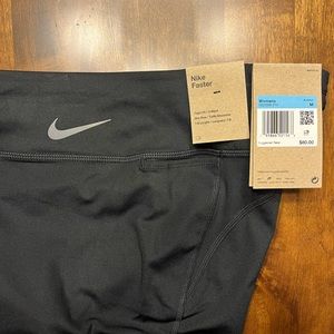 Nike Faster. Tight Fit. Mid Rise. 7/8 Length. Never worn. Tags.
